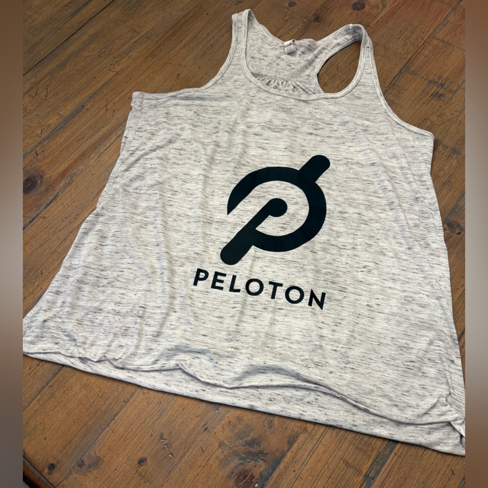 Peloton woman’s grey tank top with wording on back. Size L. Excellent condition